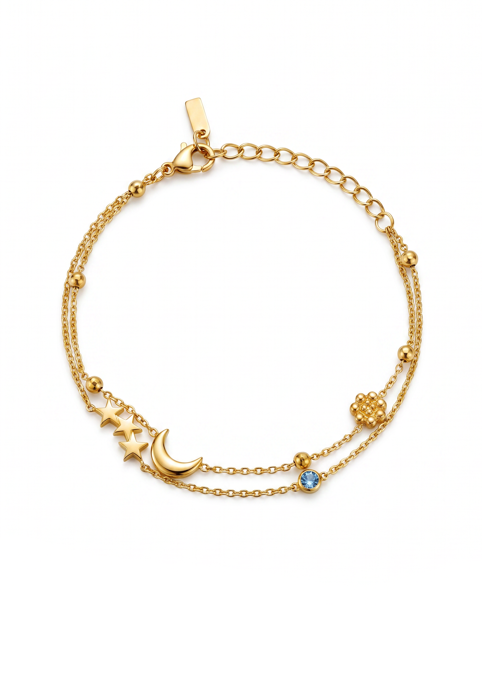 A delicate gold-toned double-strand chain bracelet featuring a crescent moon and star pendant, a small blue gemstone, and a textured gold bead accent, displayed on a clean white background.